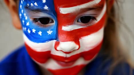 child with american flag face paint