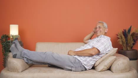 man lying on the sofa is resting.