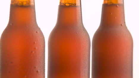 three beer bottle rotating on white background