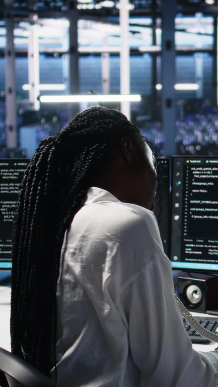 Vertical video Female technician in data center answers telephone call, assisting users with AI