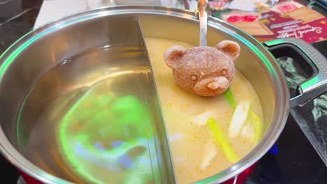 frozen bear shaped food in double hot pot