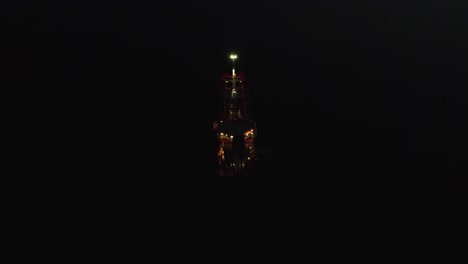 Aerial-of-boat,-oil-tanker-at-night,-top-down-view-and-pull-back,-at-night-in-the-sea