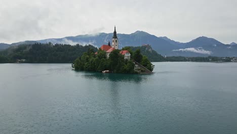 orbit drone shot of lake bled, slovenia in the morning during summer time