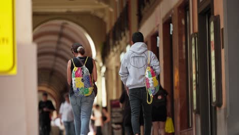 tourists strolling in centre of bologna italy in slow motion