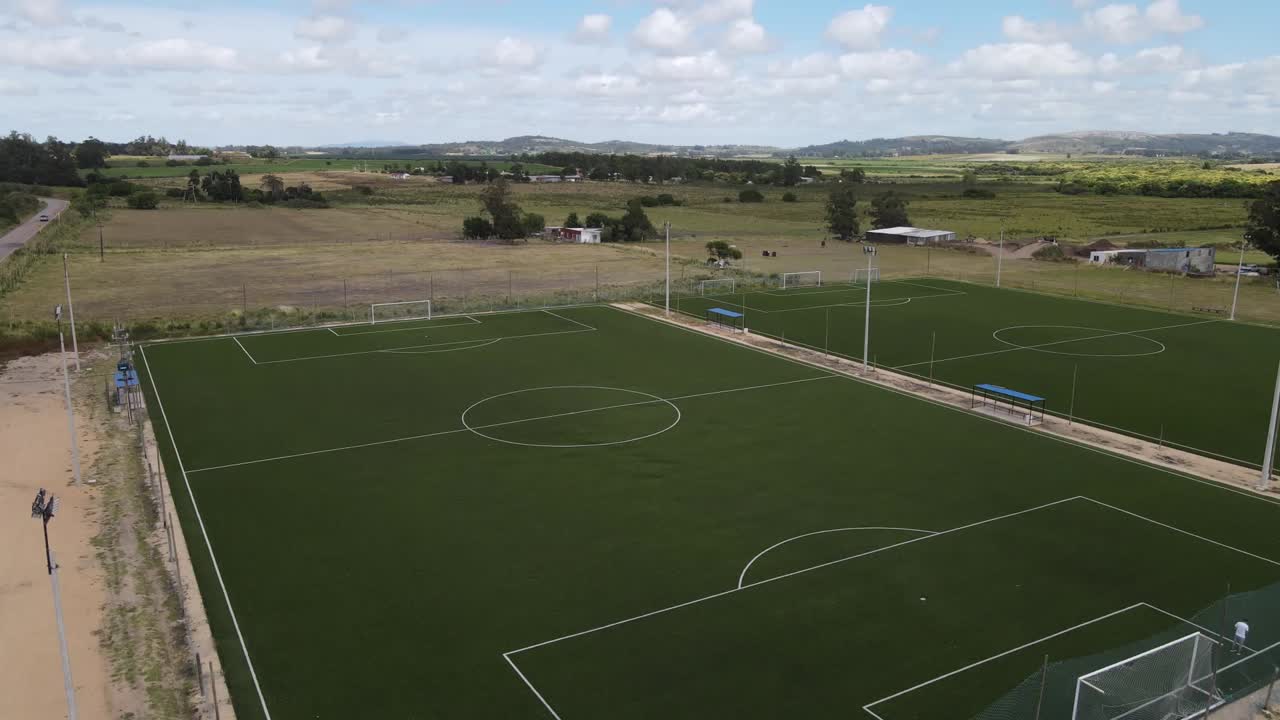Construction progress of a soccer field, transforming a rural landscape into a vibrant sports arena