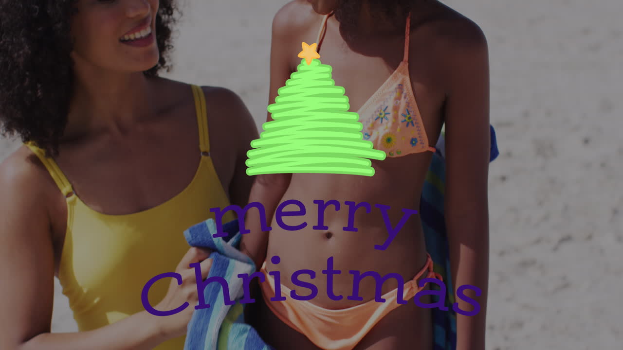 animación de saludos de navidad texto sobre madre afroamericana con hija en la playa.