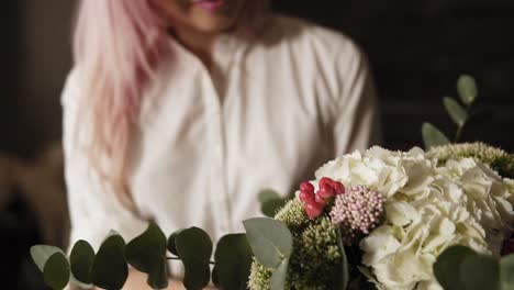 A-beautiful-bouquet-design-in-the-hands-of-a-charming-girl-with-pink-hair-and-a-white-shirt.-Slow-motion