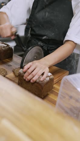 baker slicing bread