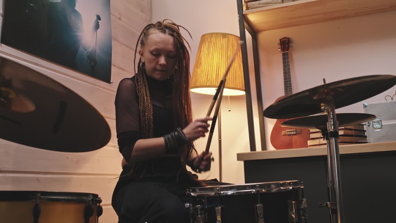Female Drummer With Dreadlocks Playing Drums