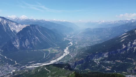 drone flies over the stunning valley of valais in switzerland with the famous rhone river, nice sunny weather