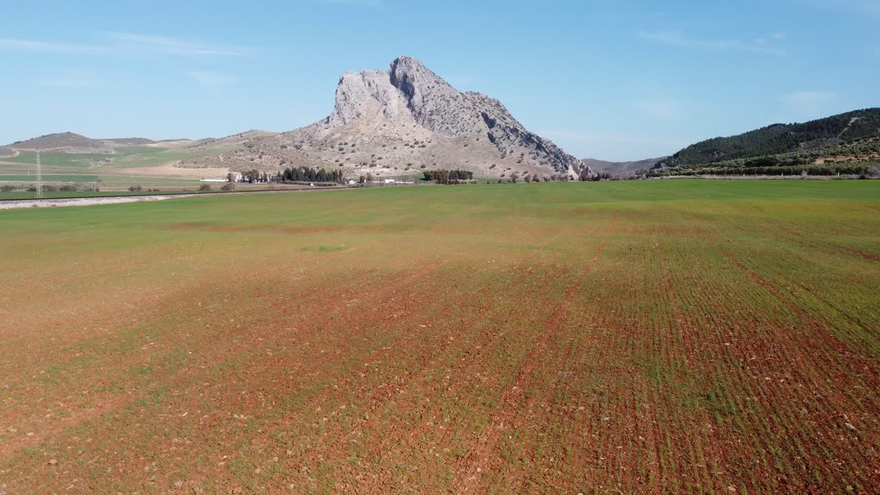 Spectacular aerial flight over the enclave of Pe&ntilde;a de los Enamorados, a rock formation in the shape of a human face in the municipality of Antequera in Andalusia, Spain