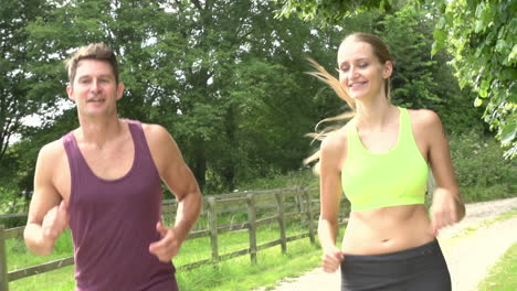 slow motion shot of couple on run in countryside together