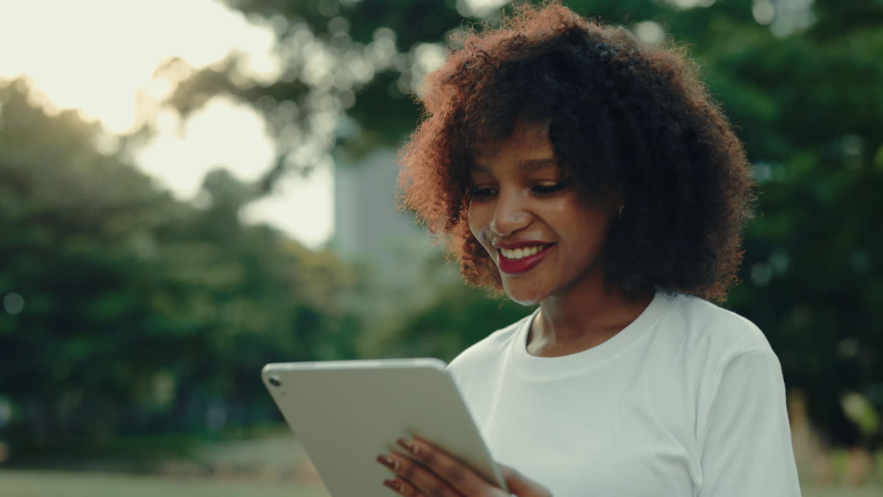Woman using a tablet in a park