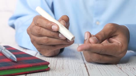 man checking his blood sugar using a glucose meter