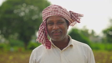 portrait of a smiling farmer in a field