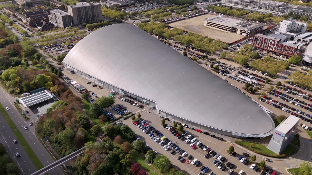 iFLY indoor skydiving aerial view orbiting futuristic sleek silver shopping centre and car park