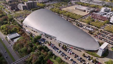 ifly indoor skydiving aerial view orbiting futuristic sleek silver shopping centre and car park