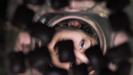 a young girl eating chocolate from a jar inside view