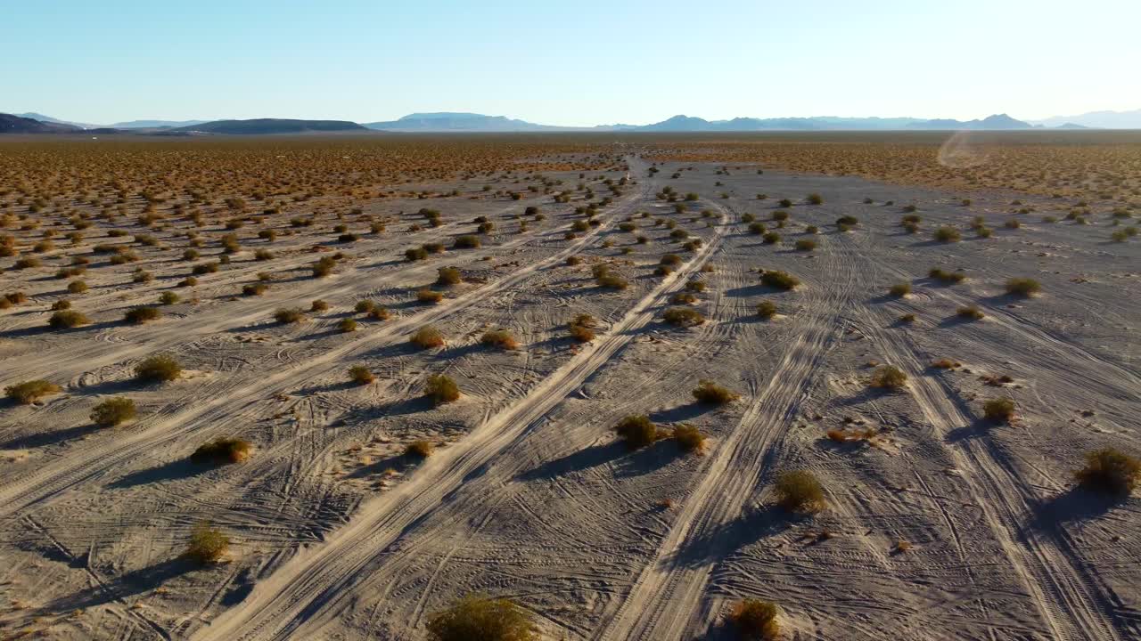 US, NV, Amargossa Valley, Big Dune, 2025-01-16 - Drone view of off road tracks in the desert at sunrise at Big Dune, also known as Amargossa Dune