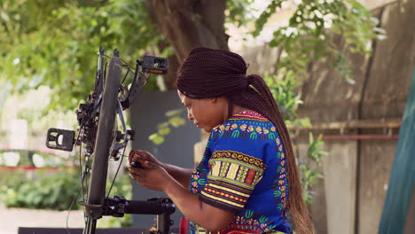 female cyclist repairing bike derailleur