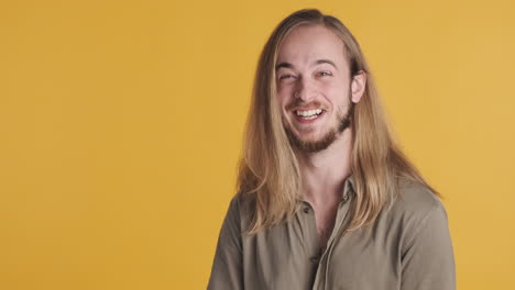 caucasian young man laughing in front of the camera.