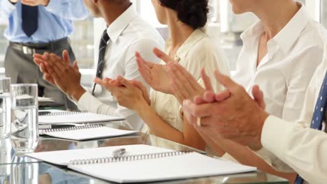 Business-people-clapping-at-presentation