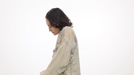 young woman posing in a studio with a white background