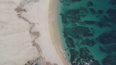 Aerial-of-Chileno-Beach,-known-for-its-stunning-natural-beauty,-clear-turquoise-waters,-abundant-marine-life,-making-it-a-favorite-spot-for-snorkeling-and-swimming