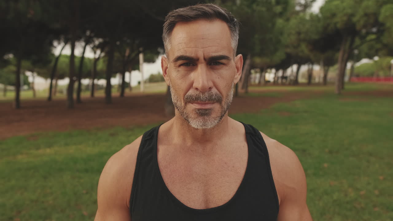 Portrait of a smiling middle-aged man in a park