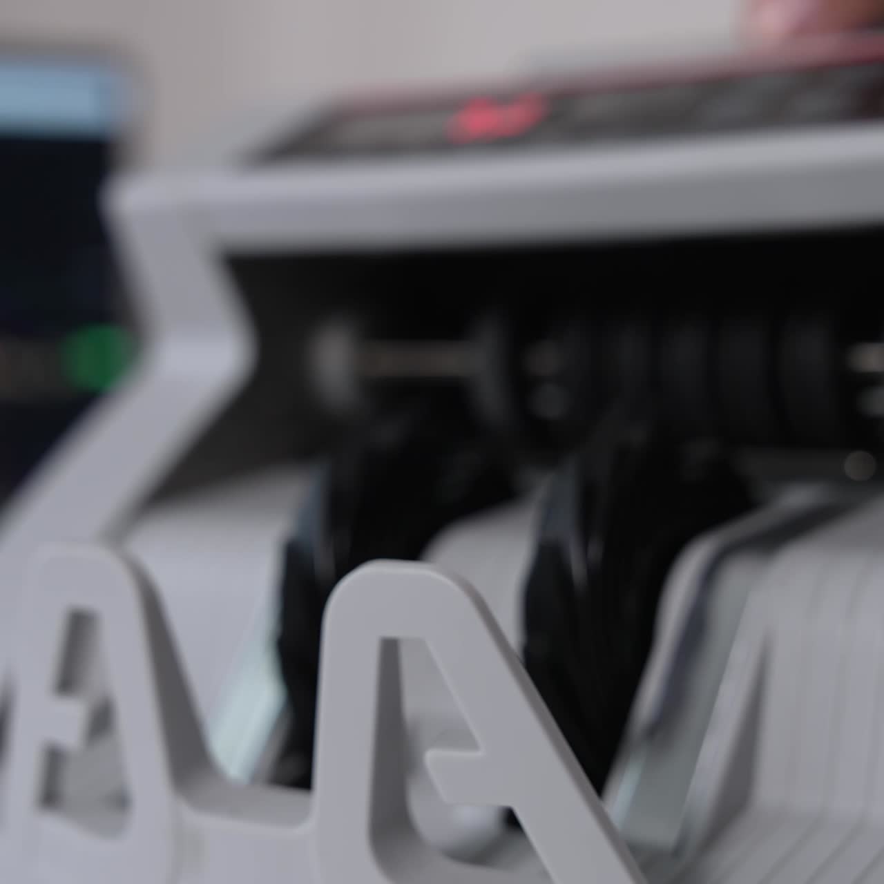 A wad of one hundred dollar bills being counted in cash machine. Apparatus for counting money blurred close up