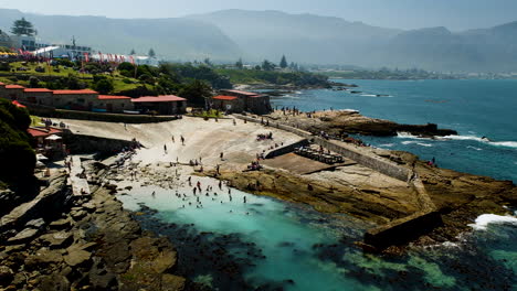 Kayaks-near-coastline-and-people-swimming-in-Hermanus