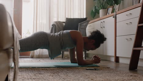 healthy woman exercising at home practicing in living room enjoying morning fitness workout