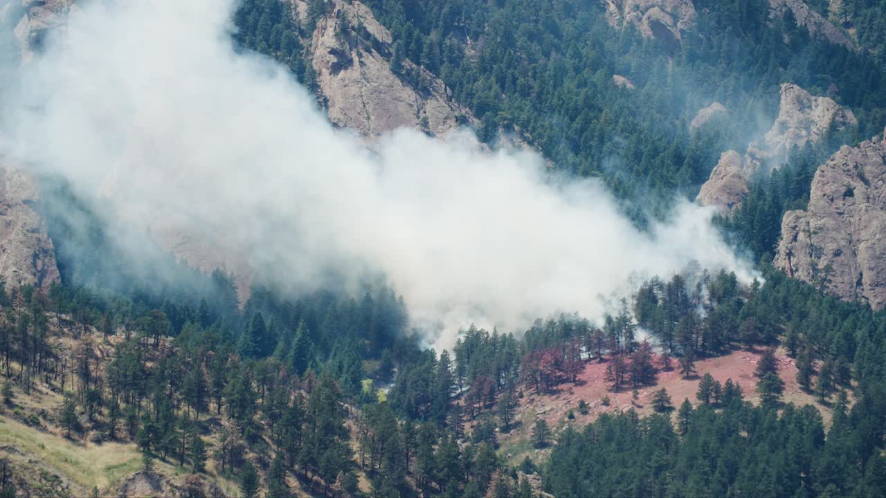 Large Plume of Smoke from a Wildfire in a Mountainous Forest