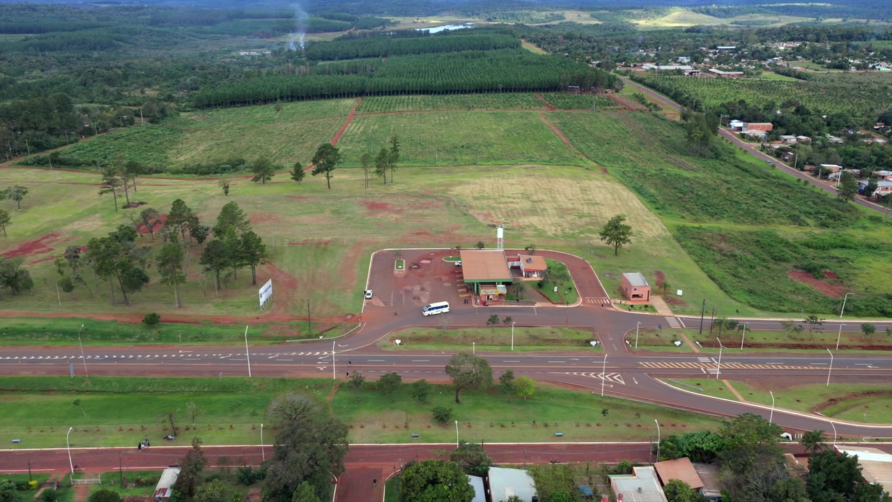 A bus terminal and adjacent green fields along Route 12 in San Ignacio, Misiones, Argentina. Ideal for transportation or regional development themes.