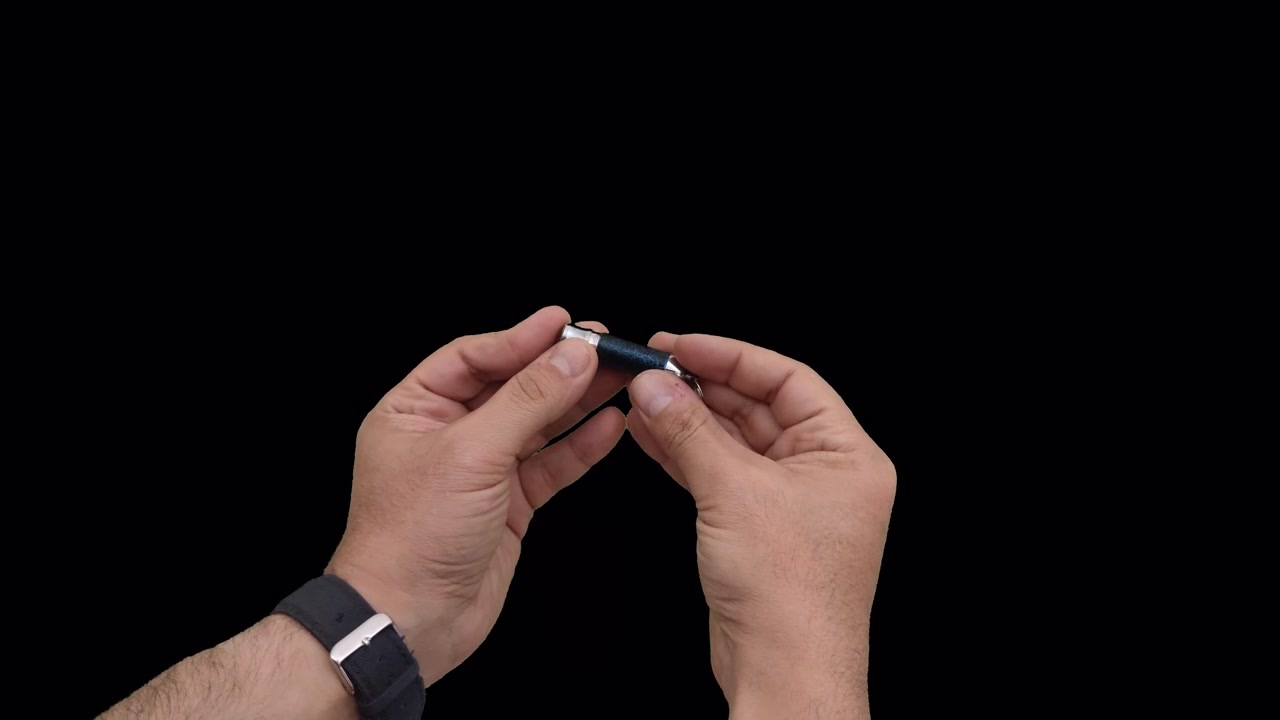 Person Assembling a Small Metal Keychain Tool