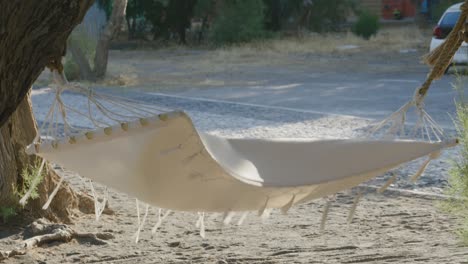 Wind-blowing-Hammock-inbetween-trees-in-Santorini,-Greece