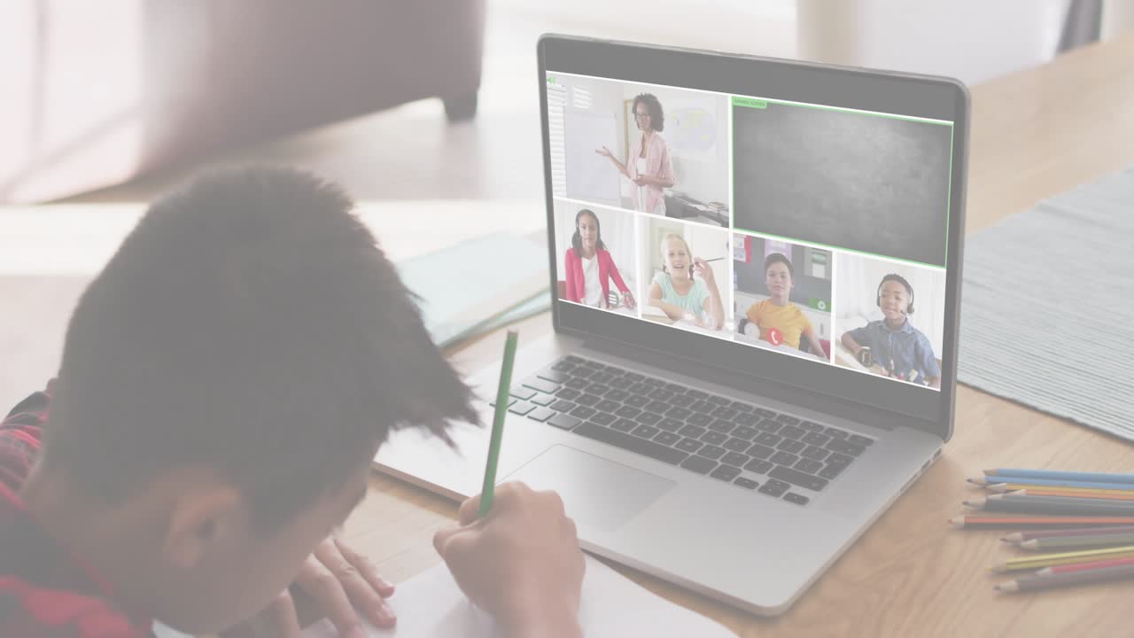 Boy writing notebook during education call, laptop prompt ANY QUESTIONS causing blue overlays