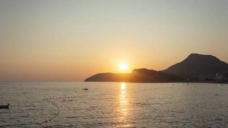 beautiful sunset on a adriatic sea beach at sutomore montenegro with mountain in the background