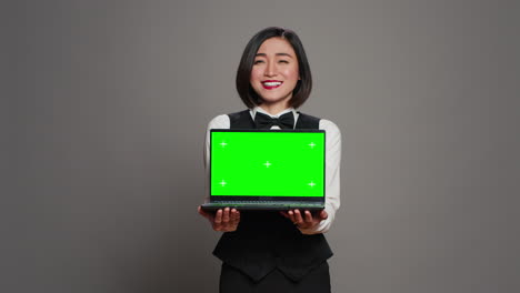 Receptionist-showing-greenscreen-display-on-personal-laptop,