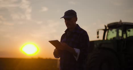 male researcher using digital tablet by machinery 16