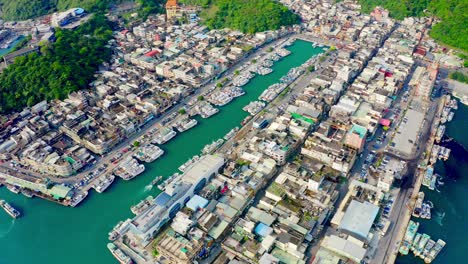 aerial birds eye shot of suao harbor with many parking ships in bay in suburb district of taipei city,taiwan