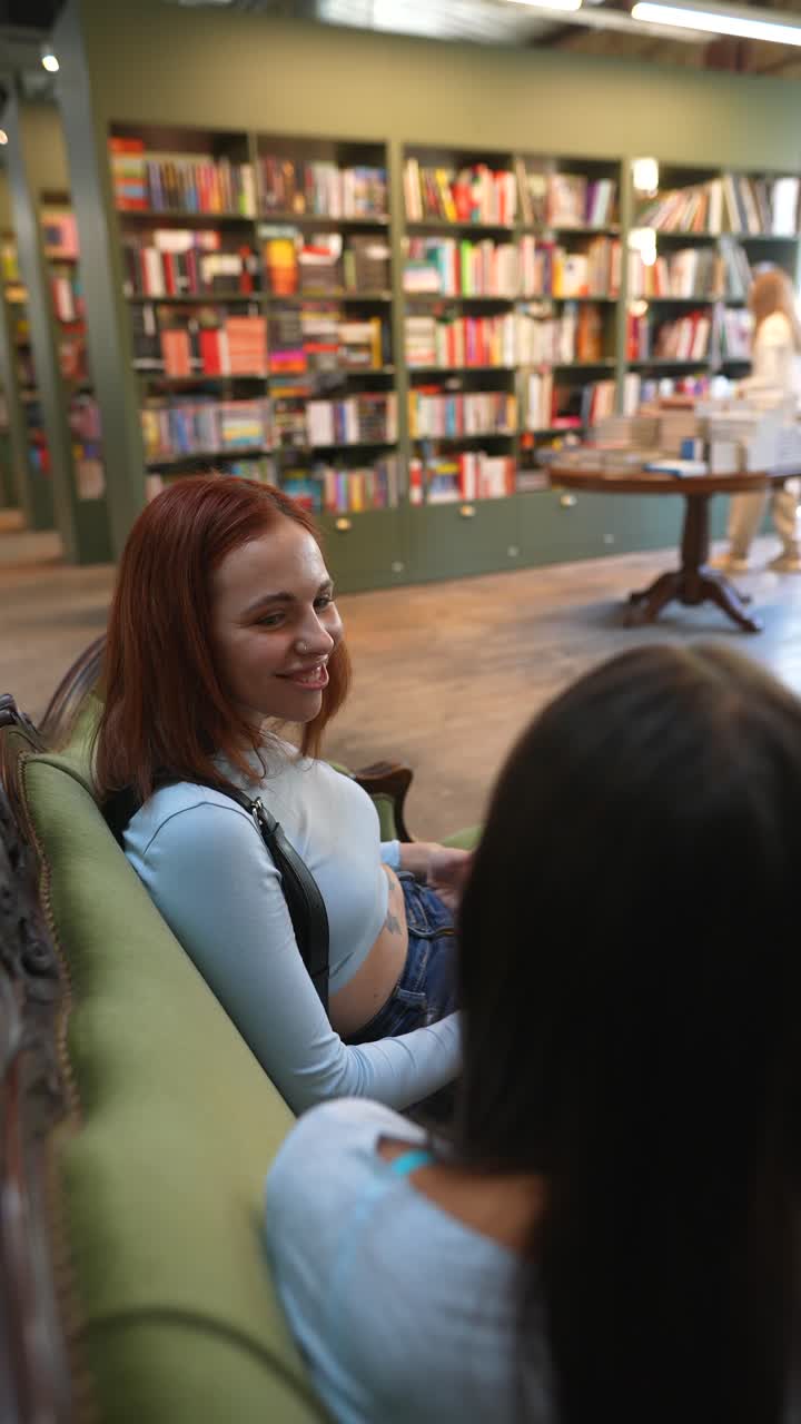 Two women friends chatting in a bookstore