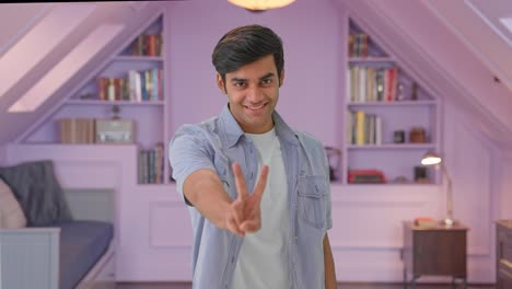 Happy-Indian-boy-showing-victory-sign