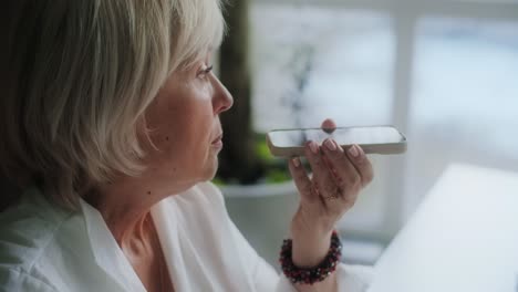 woman using voice recognition on smartphone