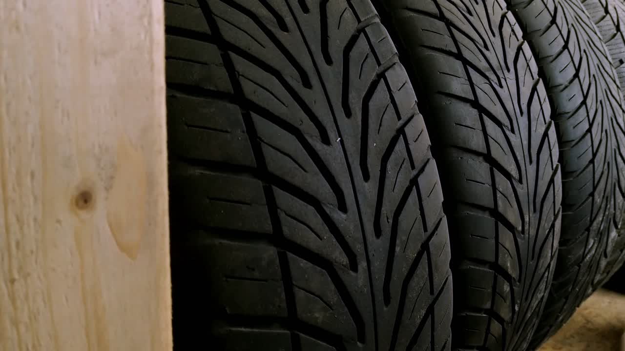 Dolly in of tyre stack in indoor store, close up view
