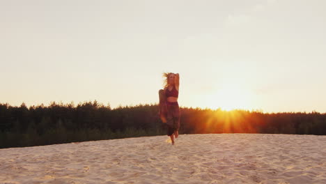 a slender woman in a light dress running on a beach at sunset