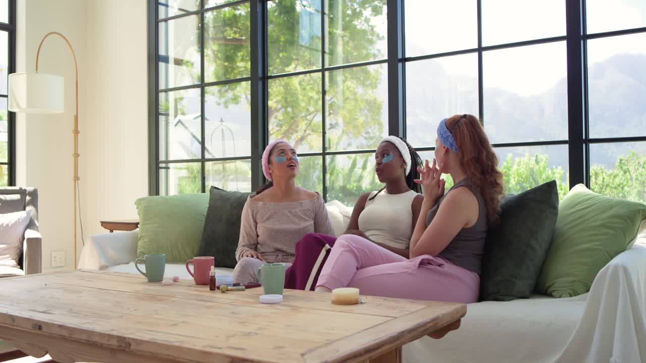 African American women tapping center, leading hugging, relaxing on sofa with skincare jars for spa