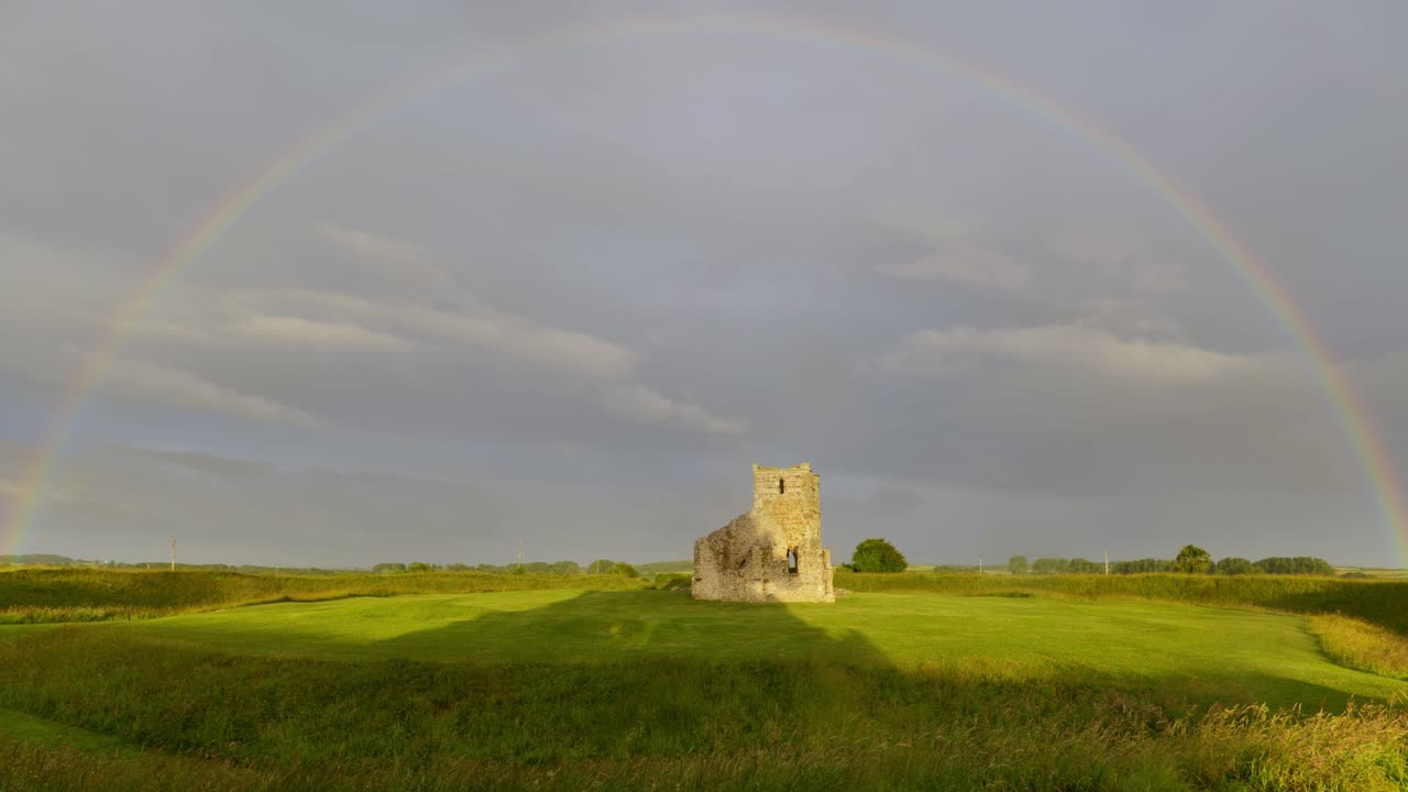 Rainbow over Knowlton Church, Dorset, England, UK.