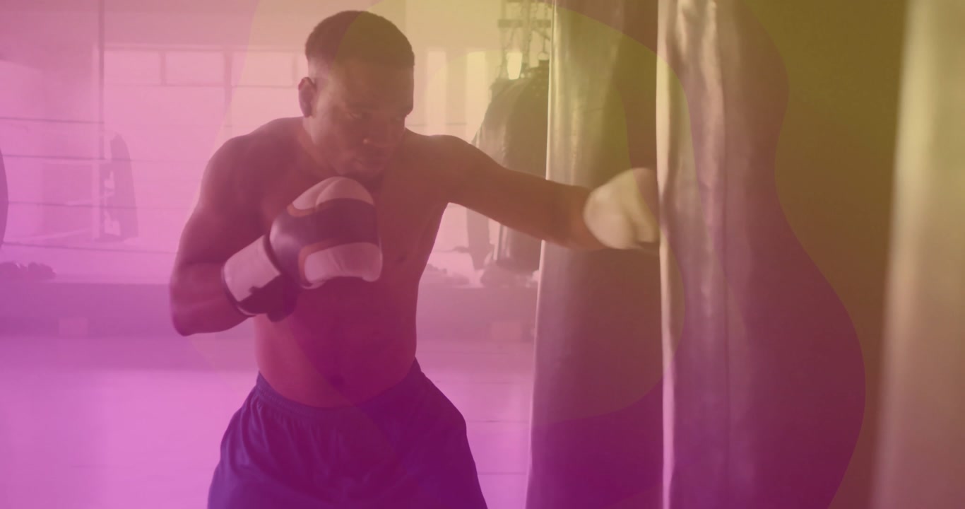 Male boxer establishing stance launching jab-cross-hook combination into bag for boxing training