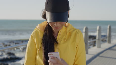 portrait pretty teenage girl using smartphone posing taking selfie photo on beautiful sunny seaside beach enjoying relaxed mobile communication